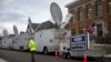 FILE - A trailer with a sign supporting Republican presidential candidate Donald Trump, and satellite trucks, are parked on the campus of Drake University in Des Moines, Iowa, Jan. 28, 2016, where Trump is scheduled to hold a campaign event. 