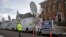 FILE - A trailer with a sign supporting Republican presidential candidate Donald Trump, and satellite trucks, are parked on the campus of Drake University in Des Moines, Iowa, Jan. 28, 2016, where Trump is scheduled to hold a campaign event. 