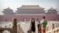 Visitors wearing face masks to protect against the new coronavirus walk through the Forbidden City in Beijing, Friday, May 1, 2020. The Forbidden City reopened beginning on Friday, China's May Day holiday, to limited visitors after being closed to…