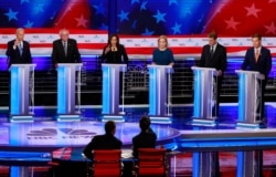 FILE - Democratic presidential candidates participate in the second night of the Democratic primary debate hosted by NBC News at the Adrienne Arsht Center for the Performing Arts in Miami, June 27, 2019.