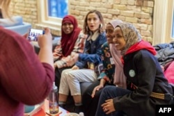 FILE - Ilhan Omar, then a Democratic congressional candidate, speaks with a group of supporters in Minneapolis, Minn., on Nov. 3, 2018.