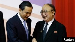 지난 2일 브루나이 국제컨벤션센터에서 열린 아세안지역안보포럼에서 북한 박의춘 외무상(오른쪽)이 왕이 중국 외교부장과 인사를 나누고 있다.