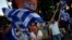 Supporters of the 'No' vote wave Greek flags after the referendum's exit poll results announced at Syntagma square, Athens, July 5, 2015.