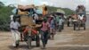 FILE - Men are seen escorting donkey carts in southern Mogadishu, Somalia, Oct. 12, 2011. Nine donkeys pulling carts with supplies to a government-controlled area have reportedly been shot dead by al-Shabab militants in the country's Bakool region.