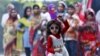 A girl dances as she takes part in celebrations after learning the initial results inside the residence of Janata Dal (United) leader Sharad Yadav in New Delhi, India.