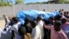FILE - Relatives carry the dead body of Somalia's public works minister Abbas Abdullahi Sheikh Siraji who was shot and killed in Somalia's capital Mogadishu, May 4, 2017. 