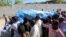 FILE - Relatives carry the dead body of Somalia's public works minister Abbas Abdullahi Sheikh Siraji who was shot and killed in Somalia's capital Mogadishu, May 4, 2017. 