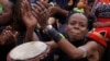 Women take part in a drumming session in downtown Johannesburg, Friday, March 8, 2013 to protest against violence against women and children. 