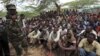 Members of al Qaida-linked militant group al Shabab listen to a Somalia government soldier after their surrender to the authorities in the north of Somalia's capital Mogadishu, September 24, 2012.