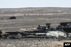 FILE - Debris of the A321 Russian airliner lie on the ground a day after the plane crashed in Wadi al-Zolomat, a mountainous area in Egypt's Sinai Peninsula, Nov. 1, 2015.