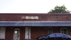 A car in front of a closed building on Aug. 12, 2021, in Bostwick, Ga. The release of information offers states the first chance to reshape their political districts, which must be done after a census to reflect population changes. (AP Photo/Brynn Anderson)