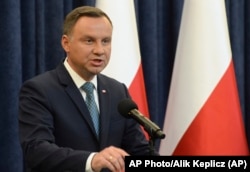 FILE - Polish President Andrzej Duda makes a statement in Warsaw, Poland, July 24, 2017.