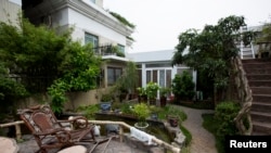 A garden is seen next to the privately-built illegal temple-like structure seen on the top of a 20-story residential block in the southern Chinese city of Shenzhen, August 22, 2013.