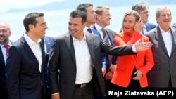 GREECE -- Macedonian Prime Minister Zoran Zaev (2ndL) welcomes Greek Prime Minister Alexis Tsipras (L), on the shore of the Lake Prespa, June 17, 2018.