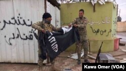بعد از شکس داعش، دو سرباز عراقی پرچم آنها را در رقه پائین آوردند. 