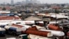 FILE - Trucks are seen parked around an automobile workshop overlooking Lagos. A recent strike by truck drivers is crippling trade between Nigeria and Cameroon.