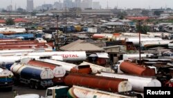 FILE - Trucks are seen parked around an automobile workshop overlooking Lagos. A recent strike by truck drivers is crippling trade between Nigeria and Cameroon.