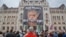 A man holds a poster of Hungarian Premier Viktor Orban that reads "What have I done again" during a protest by opposition parties against Orban's policies on migrants in Budapest, Hungary, Oct. 2, 2016. 