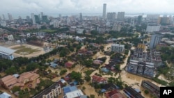 An aerial view shows the flooded George Town city in Penang, Malaysia, Sunday, Nov. 5, 2017. A northern Malaysian state has been paralyzed by a severe storm that led to two deaths and some 2,000 people evacuated in the worst flooding in years,…