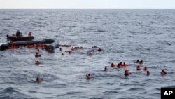 Refugees and migrants are rescued by members of the Spanish NGO Proactiva Open Arms, after leaving Libya trying to reach European soil aboard an overcrowded rubber boat in the Mediterranean sea, Wednesday, Nov. 11, 2020. The Open Arms rescue ship…