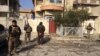 Iraqi forces guard suspected militants near the frontlines in Mosul, Jan. 13, 2017.