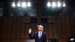 FILE - Judge Merrick Garland, nominee to be Attorney General, is sworn in at his confirmation hearing before the Senate Judiciary Committee, on Capitol Hill in Washington, Feb. 22, 2021.