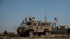 An American armored vehicle patrols with Turkish forces, as they conduct their second joint ground patrol in the "safe zone" on the Syrian side of the border with Turkey, in Rahaf village, near the town of Tal Abyad, northeastern Syria, Sept. 24, 2019.