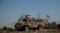 An American armored vehicle patrols with Turkish forces, as they conduct their second joint ground patrol in the "safe zone" on the Syrian side of the border with Turkey, in Rahaf village, near the town of Tal Abyad, northeastern Syria, Sept. 24, 2019.