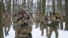 FILE - Members of Ukraine's Territorial Defense Forces, volunteer military units of the armed forces, train in a city park in Kyiv, Jan. 22, 2022.