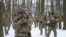 FILE - Members of Ukraine's Territorial Defense Forces, volunteer military units of the armed forces, train in a city park in Kyiv, Jan. 22, 2022.