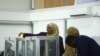 FILE - A Somali lawmaker casts her vote to elect a new president, inside Mogadishu airport, in Mogadishu, Somalia, Feb. 8, 2017.