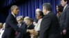 President Barack Obama greets invited guests at the Eisenhower Executive Office Building in Washington, Nov. 28, 2012.