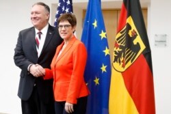 German Defense Minister Annegret Kramp-Karrenbauer, right, shakes hands with U.S. Secretary of State Mike Pompeo, prior to a meeting at the Defense Ministry in Berlin, Germany, Nov. 8, 2019.
