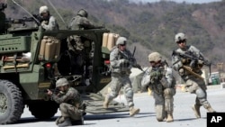 A toy doll is pictured near a damaged school following recent Russian shelling in the city of Slovyansk, in Donetsk region, Ukraine.