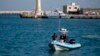 FILE - Italian police patrol a port in southern Italy, April 20, 2018. 