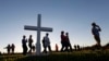 Attendees pass a wooden cross as they arrive at a candlelight vigil for the victims of the shooting at Marjory Stoneman Douglas High School in Parkland, Florida, Feb. 15, 2018. 