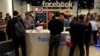 FILE - People stop at the Facebook booth at the Conservative Political Action Conference (CPAC) at National Harbor, Maryland, U.S., Feb. 23, 2018. 