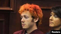 Colorado shooting suspect James Eagan Holmes (L) sits with public defender Tamara Brady during his first court appearance in Aurora, Colorado, July 23, 2012. 