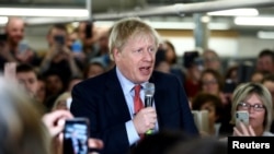 Britain's Prime Minister Boris Johnson delivers a speech during a meeting with workers as he visits John Smedley Mill in Matlock, Derbyshire, Britain, Dec. 5, 2019.