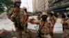 Paramilitary soldiers stand guard near the dismantled makeshift tents of the supporters of Muttahida Qaumi Movement (MQM) political party after a protest, in Karachi, Pakistan, Aug. 22, 2016.