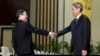 Wang Yu-chi, left, head of Taiwan's Mainland Affairs Council, shakes hands with Zhang Zhijun, director of China's Taiwan Affairs Office, Nanjing, Feb. 11, 2014.