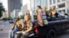 FILE - Black Lives Matter protester Jaborey Burns (C) rides around with members of the Texas Guerrillas as they patrol a Black Lives Matter rally in Austin, Texas, Aug. 1, 2020. 