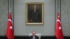 Turkey's President Recep Tayyip Erdogan, backdropped by a painting depicting modern Turkey's founder Mustafa Kemal Ataturk, chairs his government's cabinet in Ankara, Turkey, April 26, 2021.