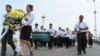 Mourners gather to pay respects to the late former Cambodian King Norodom Sihanouk in front of the Royal Palace in Phnom Penh, October 16, 2012. 