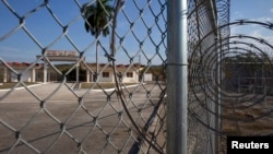 The Northeast gate marks the end of U.S. soil as the road leads into Cuba at Guantanamo Bay U.S. Naval Base, March 8, 2013. 