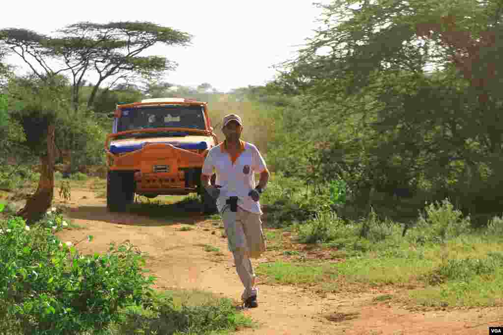 A runner for Car 11, the Frying Squad, shows his driver how to find the next checkpoint, June 2, 2012. (VOA/Jill Craig)