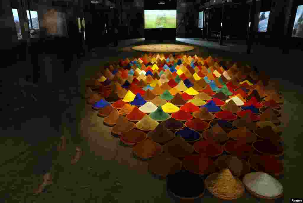 A visitor walks past an installation called &quot;Campo de Color&quot; by Bolivian artist Sonia Falcone, May 28, 2013. 