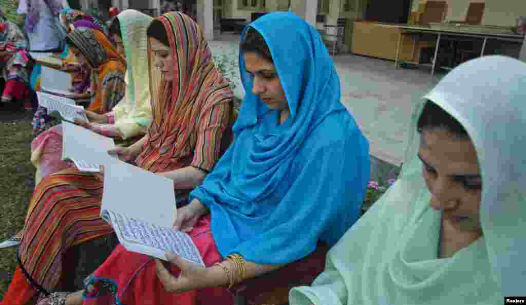 Teachers recite verses from the Koran as they pray for the recovery of Malala Yousufzai, Peshawar, Pakistan, October 12, 2012. 
