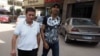 Once physically female, Mohammad Alaam (L) and his friend stroll through a Cairo suburb, June 13, 2016. (H. Elrasam/VOA)