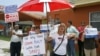 Supporters of Republican presidential candidate, former Massachusetts Gov. Mitt Romney protest the opening of a new Obama For America-Florida office in the Little Havana area of Miami, August 2, 2012.